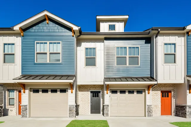 a front view of a residential apartment building with a yard