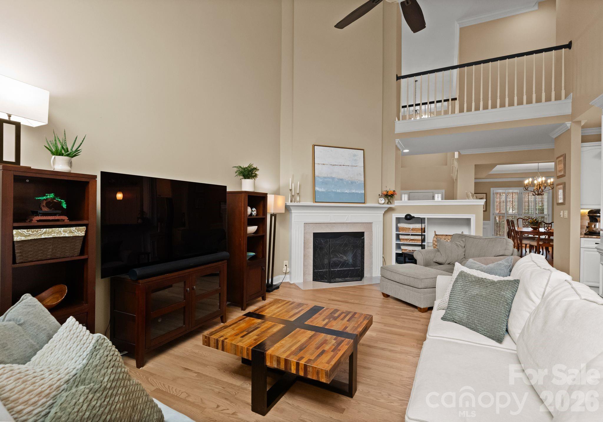 10012 Paradise Ridge Road Charlotte, NC 28277 - Photo 11 of 48 a living room with furniture a flat screen tv and a fireplace