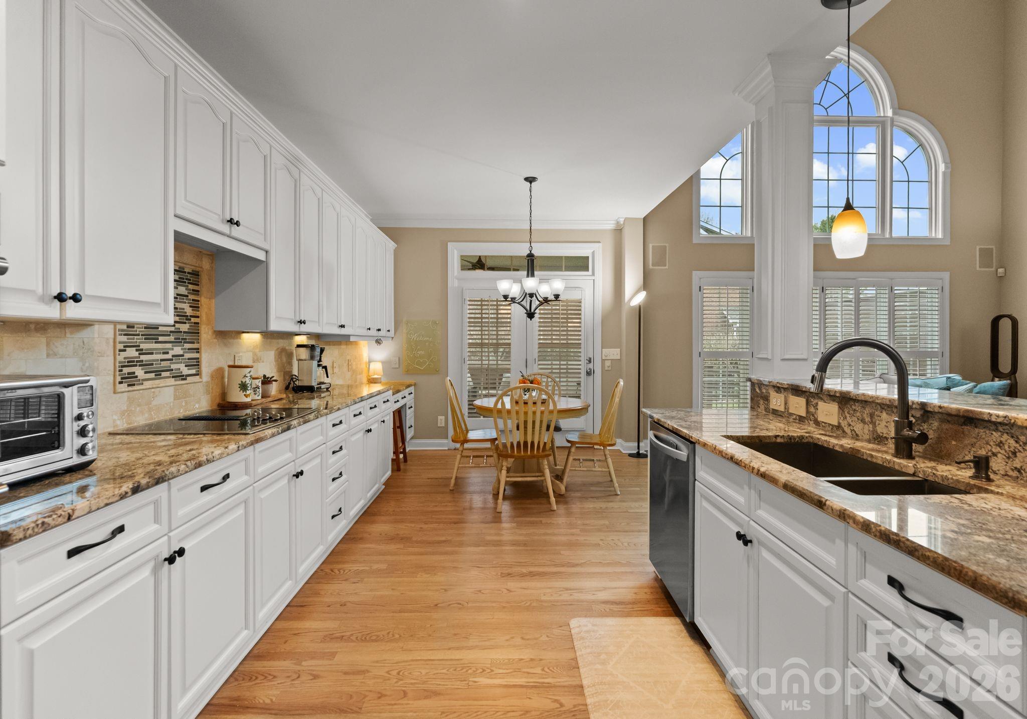 10012 Paradise Ridge Road Charlotte, NC 28277 - Photo 13 of 48 a large kitchen with stainless steel appliances granite countertop a sink a stove counter space and cabinets