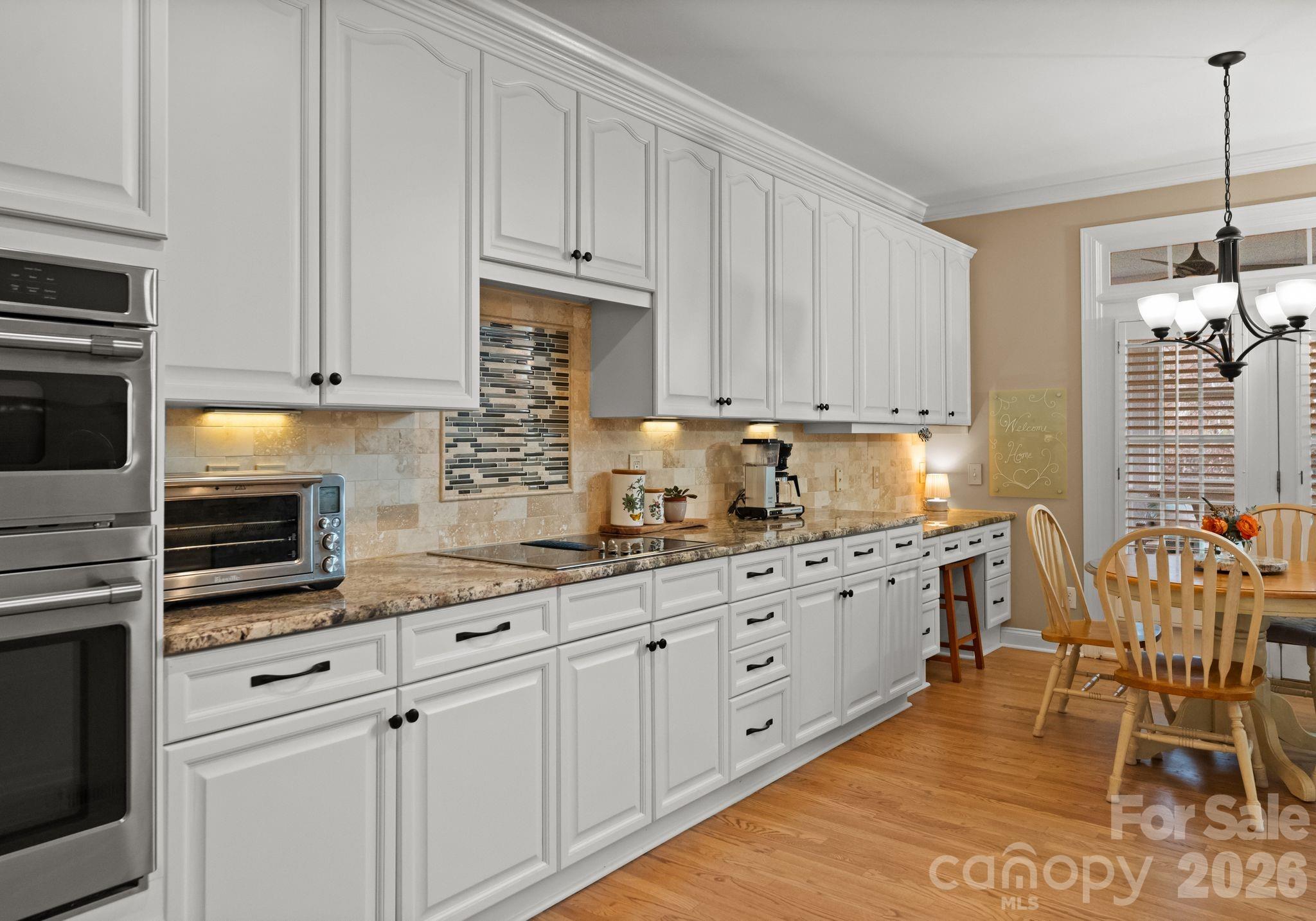 10012 Paradise Ridge Road Charlotte, NC 28277 - Photo 14 of 48 a kitchen with granite countertop white cabinets and white appliances