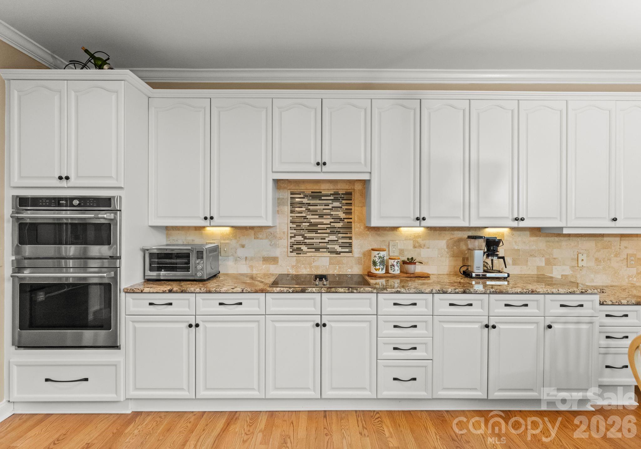 10012 Paradise Ridge Road Charlotte, NC 28277 - Photo 15 of 48 a kitchen with granite countertop white cabinets and stainless steel appliances