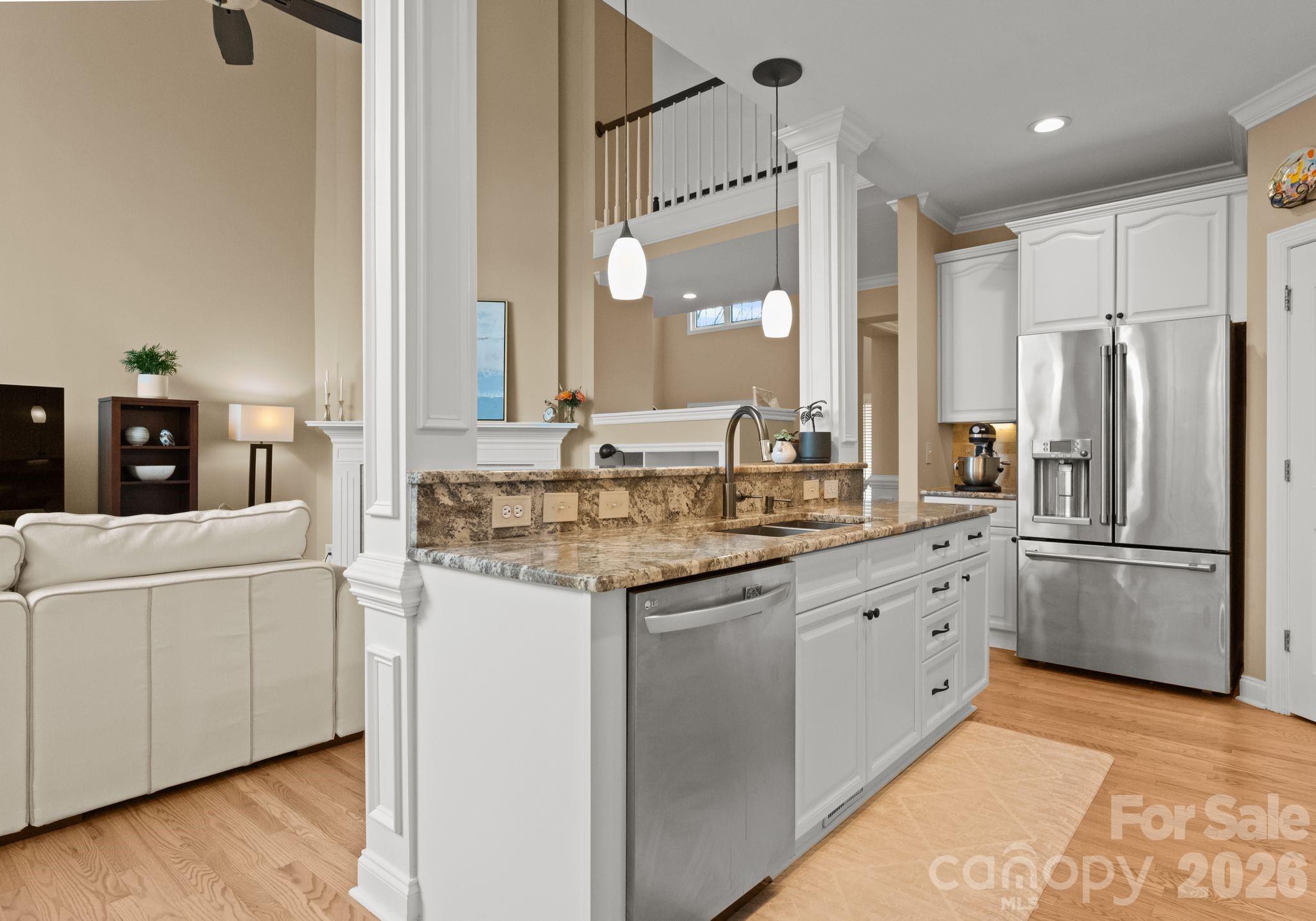 10012 Paradise Ridge Road Charlotte, NC 28277 - Photo 17 of 48 a kitchen with stainless steel appliances granite countertop a refrigerator a sink and white cabinets