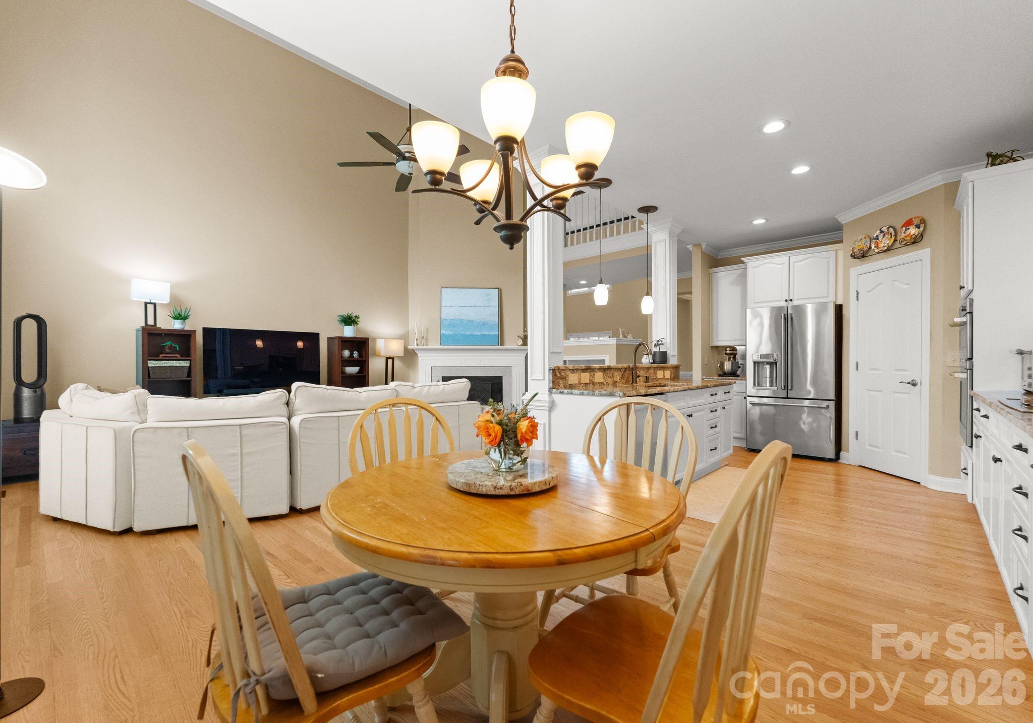 10012 Paradise Ridge Road Charlotte, NC 28277 - Photo 18 of 48 a living room with kitchen island furniture and a chandelier