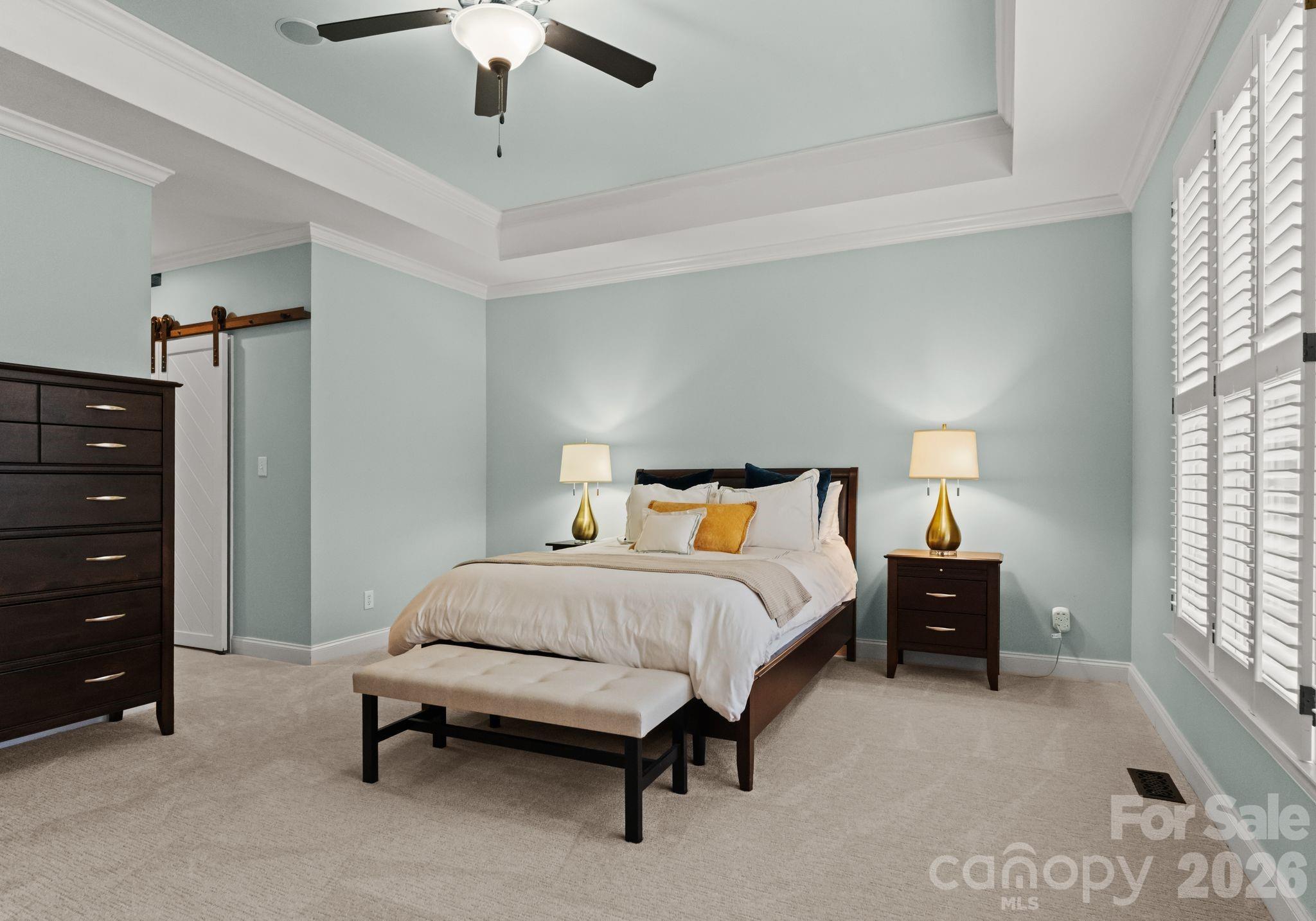 10012 Paradise Ridge Road Charlotte, NC 28277 - Photo 20 of 48 a bedroom with a bed and a chandelier
