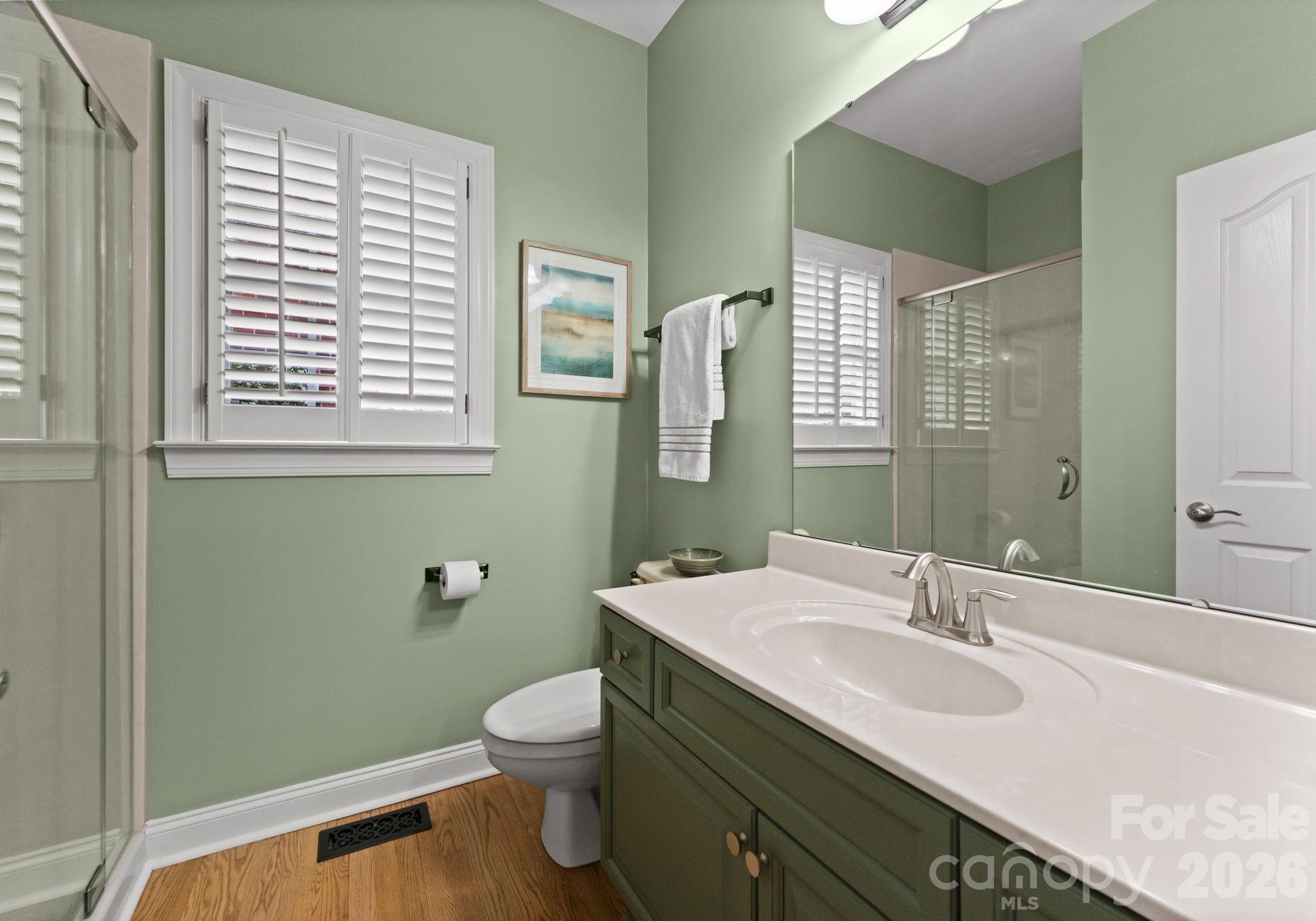 10012 Paradise Ridge Road Charlotte, NC 28277 - Photo 26 of 48 a bathroom with a granite countertop sink toilet a mirror and a window