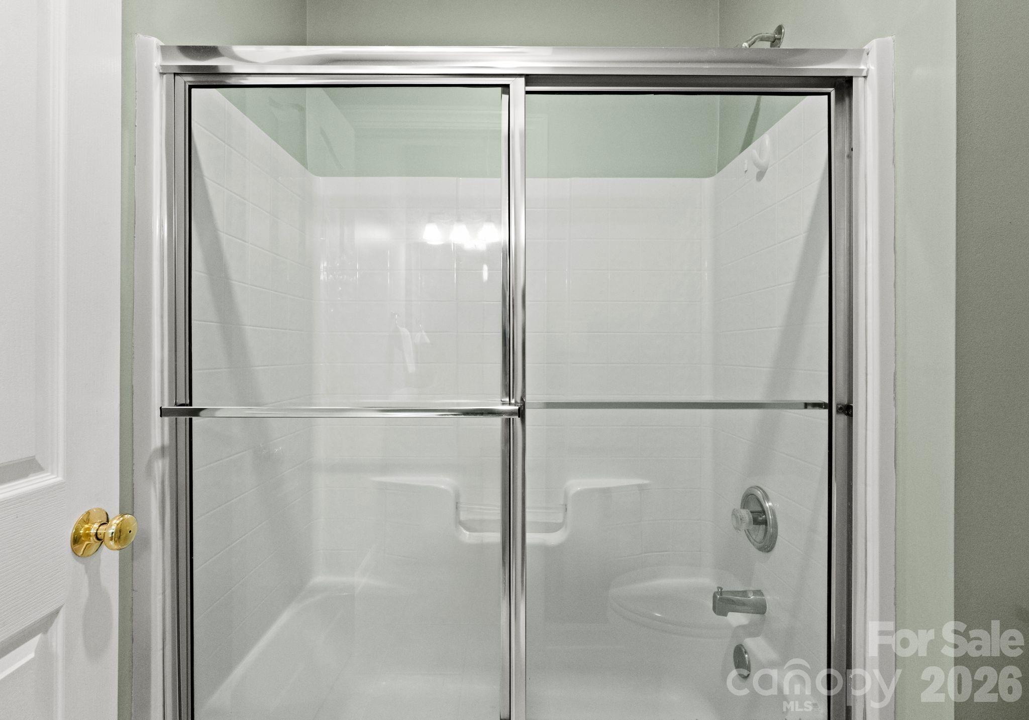 10012 Paradise Ridge Road Charlotte, NC 28277 - Photo 31 of 48 a bathroom with a glass shower door