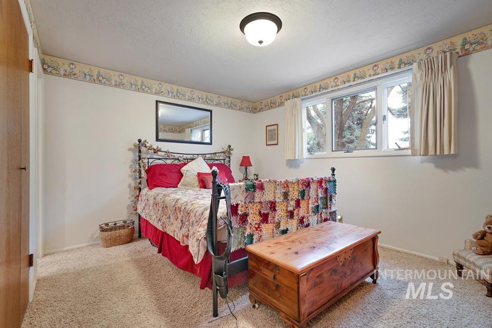 9518 Scorpio Street Boise, ID 83709 - Photo 18 of 46 Carpeted bedroom featuring a textured ceiling and baseboards