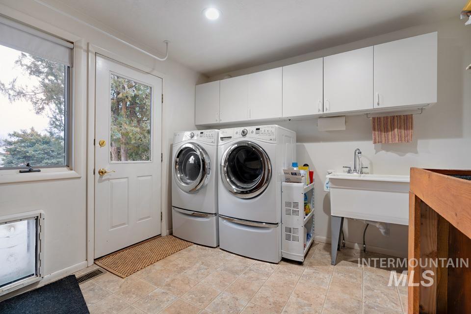 9518 Scorpio Street Boise, ID 83709 - Photo 23 of 46 Washroom featuring separate washer and dryer and cabinet space