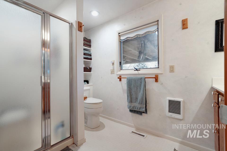 9518 Scorpio Street Boise, ID 83709 - Photo 29 of 46 Full bathroom featuring a shower stall, vanity, heating unit, and recessed lighting