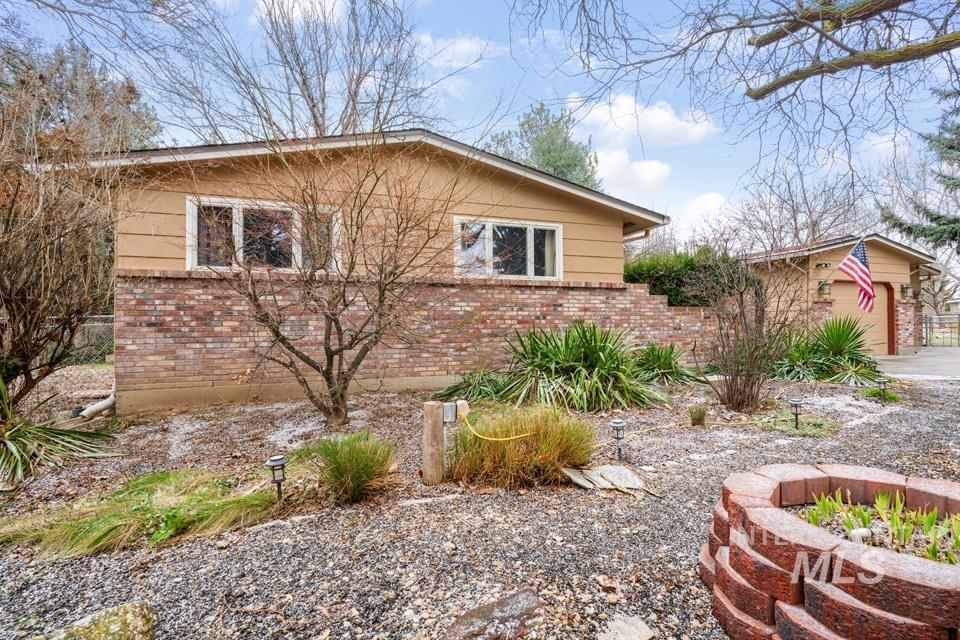 9518 Scorpio Street Boise, ID 83709 - Photo 3 of 46 View of side of property featuring brick siding and a garage