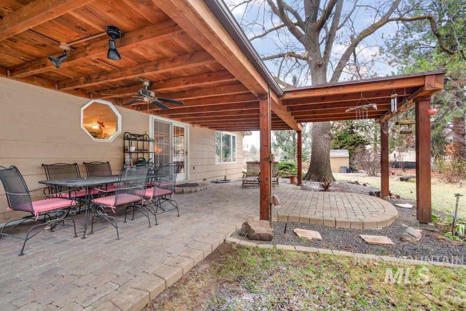 9518 Scorpio Street Boise, ID 83709 - Photo 35 of 46 View of patio / terrace with outdoor dining area, ceiling fan, and a fire pit