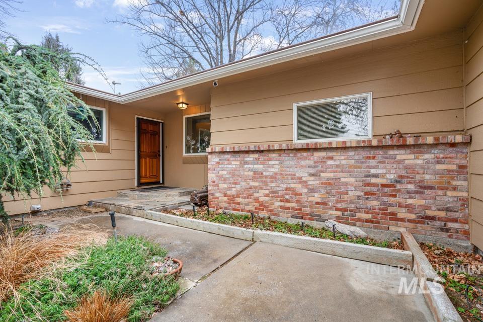 9518 Scorpio Street Boise, ID 83709 - Photo 4 of 46 View of exterior entry featuring a patio and brick siding