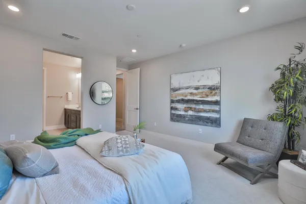 a bedroom with furniture and a large mirror