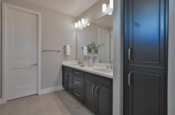 a bathroom with a double vanity sink and a mirror