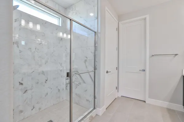 a bathroom with a glass shower door