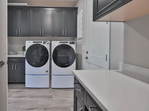 a utility room with sink dryer and washer