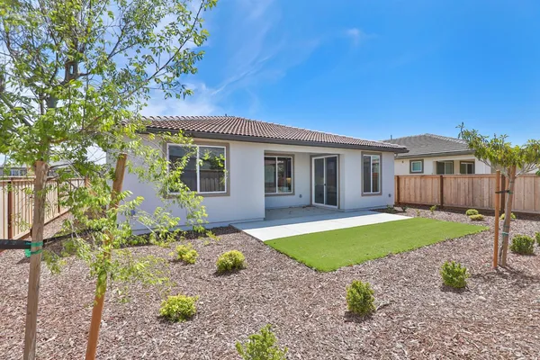 a view of a house with backyard and sitting area