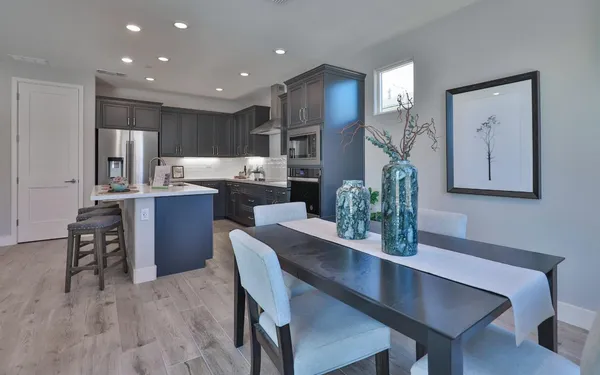a dining room with furniture and wooden floor