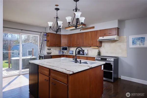 a kitchen with a sink a counter top space and stainless steel appliances