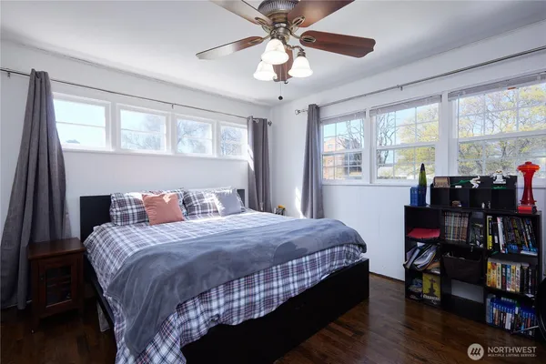 a bedroom with a bed furniture and a large window