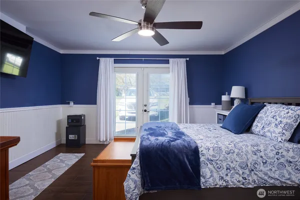 a bedroom with a large bed and a chandelier