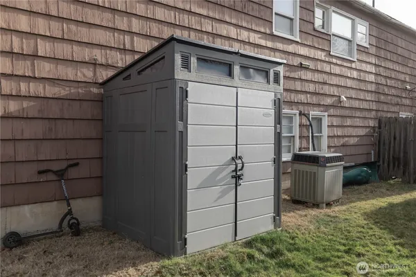 a view of a wooden door and brick wall