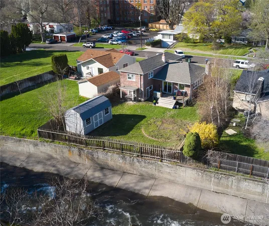 an aerial view of a house with garden space and street view