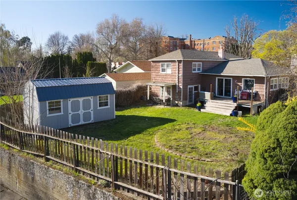 a view of a house with wooden fence
