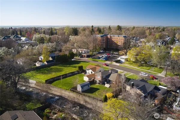 an aerial view of a house with a garden and lake view