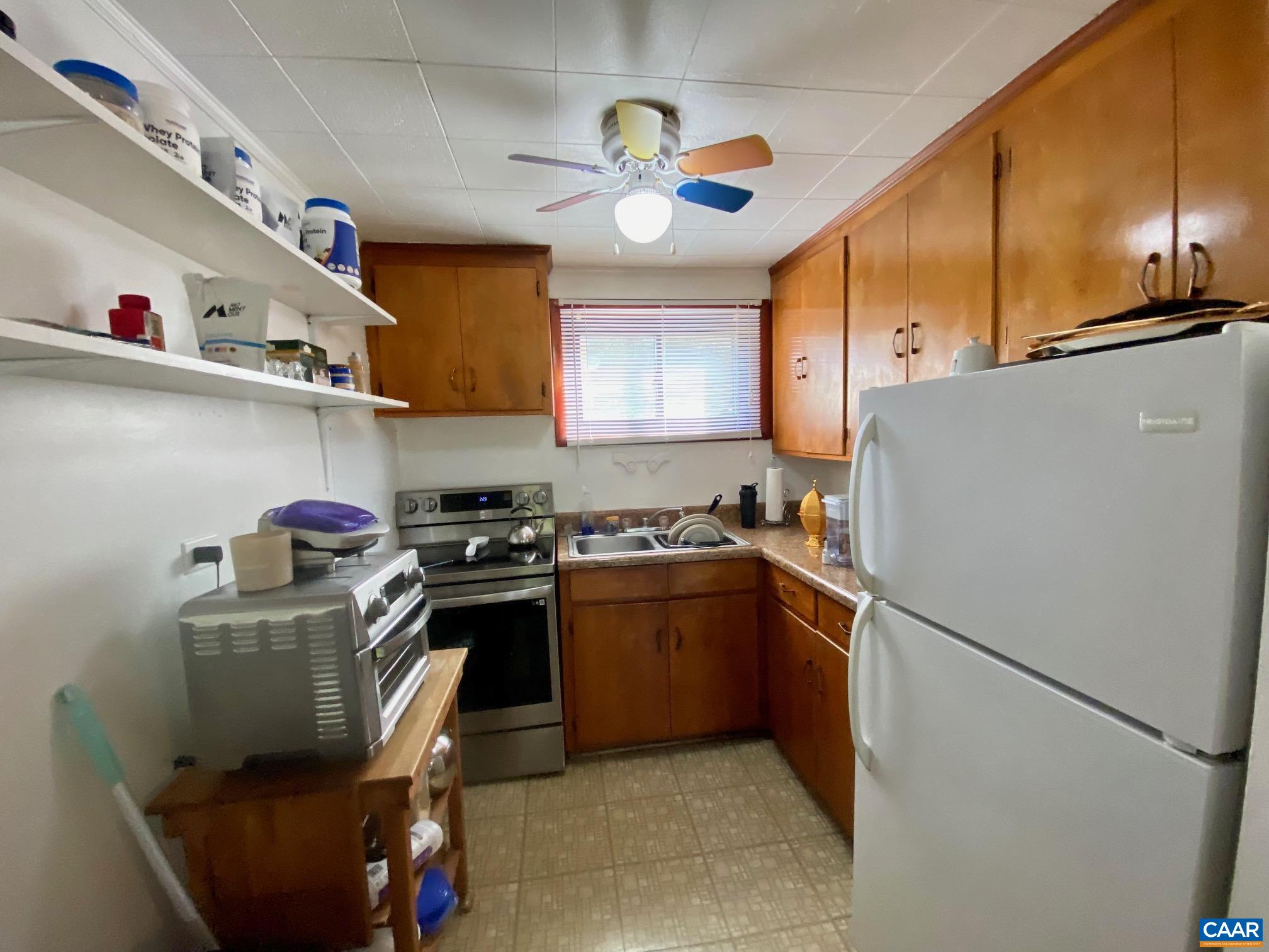 115 Apple Tree Road Charlottesville, VA 22903 - Photo 13 of 17 a kitchen with stainless steel appliances granite countertop a refrigerator a stove and a sink