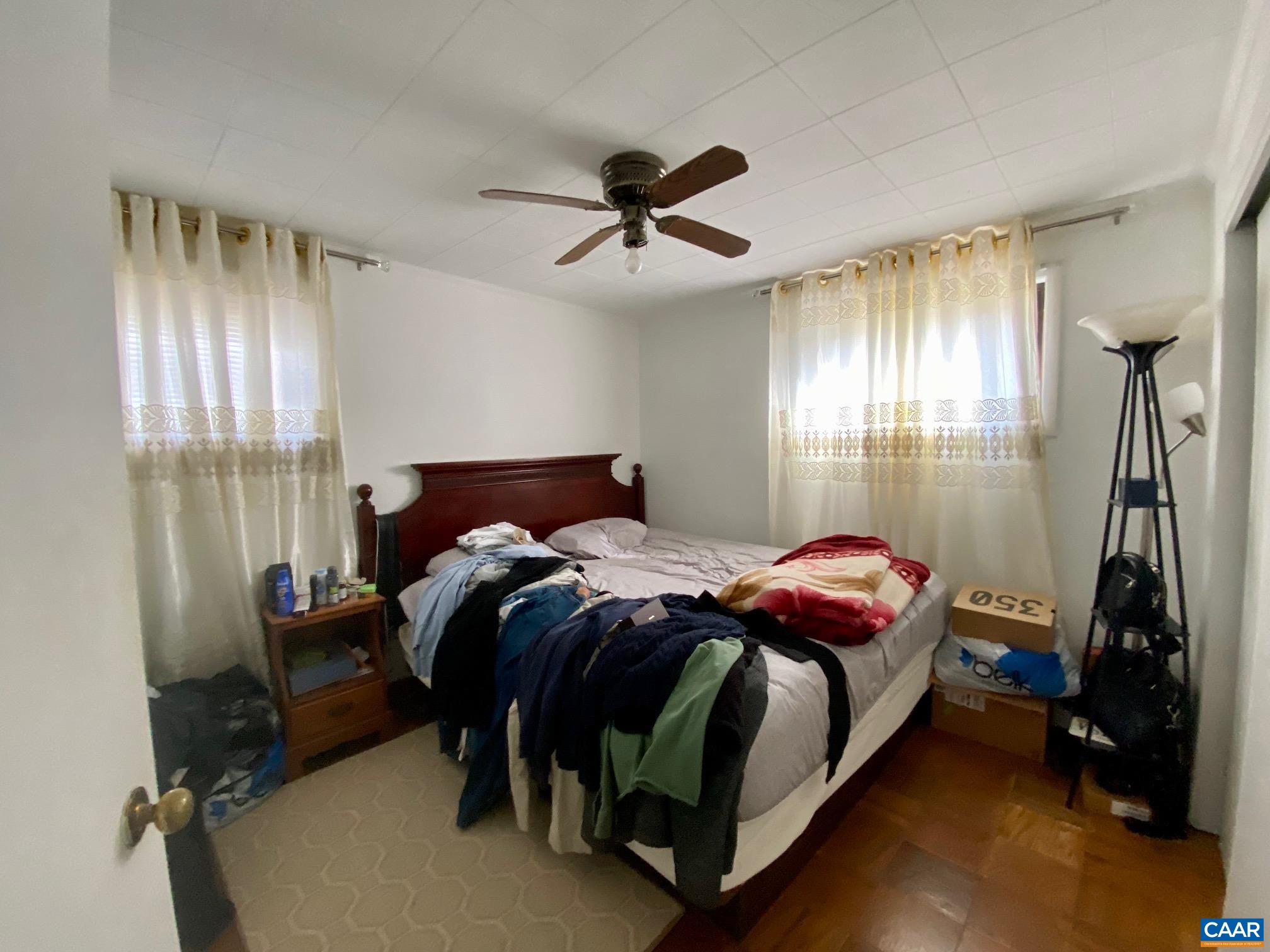 115 Apple Tree Road Charlottesville, VA 22903 - Photo 16 of 17 a bedroom with a bed and a chandelier
