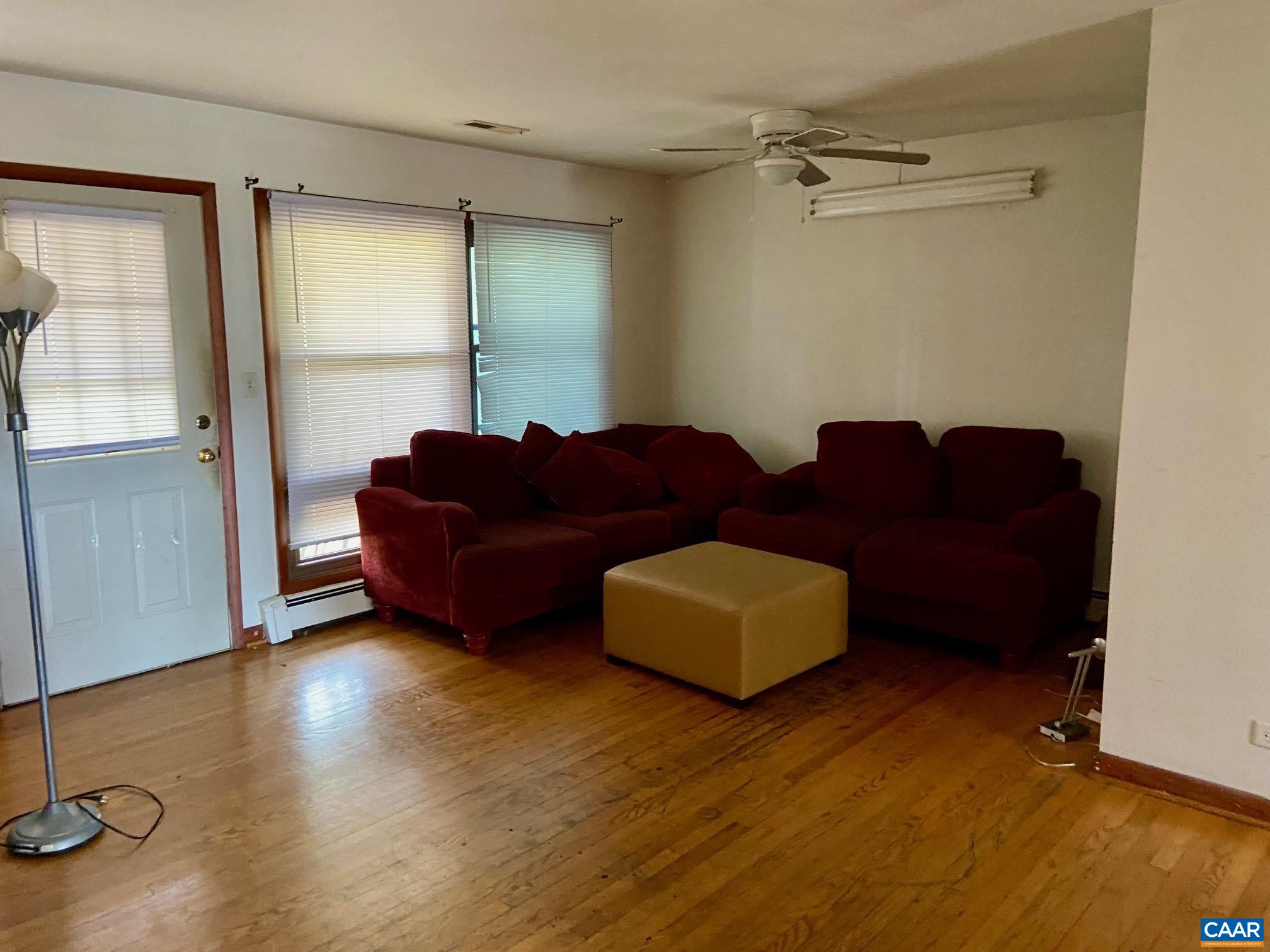 115 Apple Tree Road Charlottesville, VA 22903 - Photo 2 of 17 a living room with couches and a coffee table with wooden floor