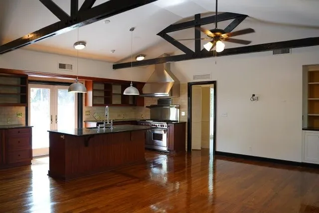 a kitchen with stainless steel appliances granite countertop a refrigerator a sink and a stove