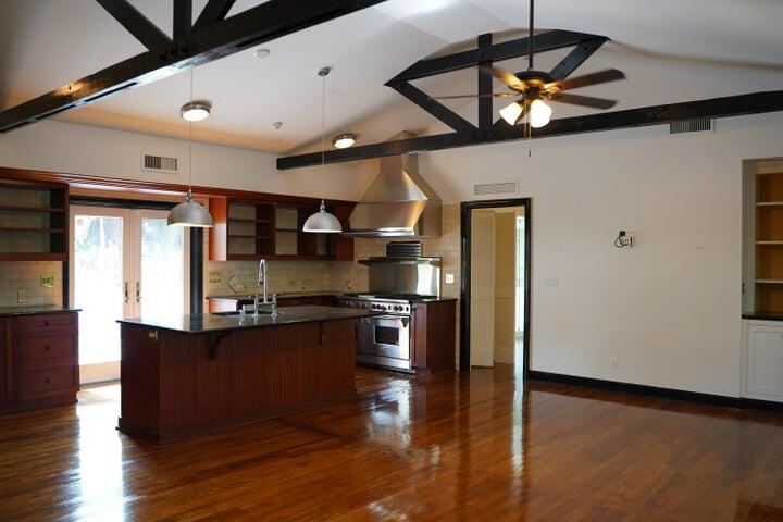 5215 North Flagler Drive West Palm Beach, FL 33407 - Photo 12 of 37 a kitchen with stainless steel appliances granite countertop a stove and a refrigerator