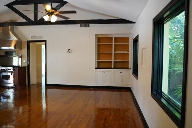 a kitchen with kitchen island granite countertop a sink stainless steel appliances and cabinets