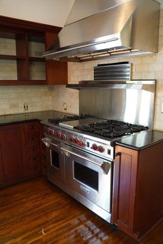 5215 North Flagler Drive West Palm Beach, FL 33407 - Photo 16 of 37 a stove top oven sitting inside of a kitchen