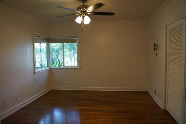 a view of a room with wooden floor and window