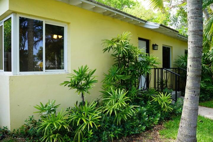 5215 North Flagler Drive West Palm Beach, FL 33407 - Photo 2 of 37 front view of a house with a plant
