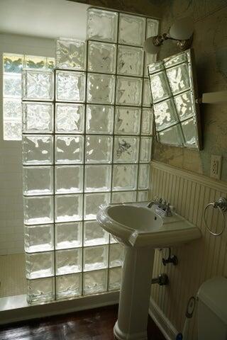 5215 North Flagler Drive West Palm Beach, FL 33407 - Photo 22 of 37 a bathroom with a sink and a window