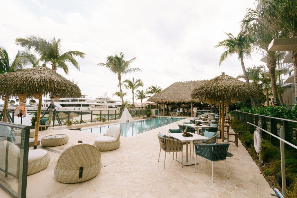 5215 North Flagler Drive West Palm Beach, FL 33407 - Photo 29 of 37 a view of a swimming pool with a lounge chair and palm trees