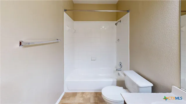 a bathroom with a toilet and a bath tub