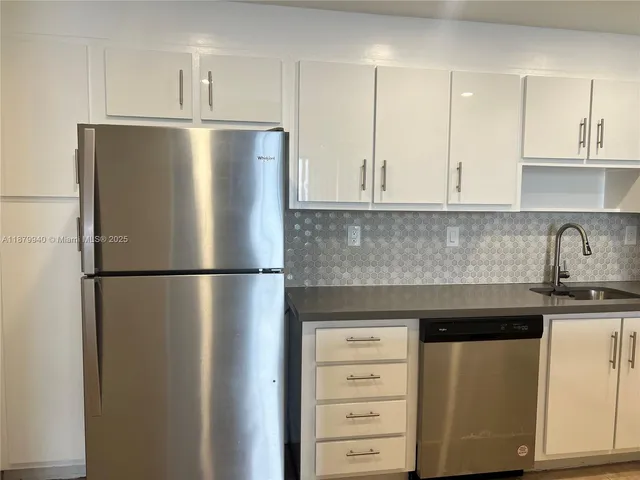 a white refrigerator freezer sitting in a kitchen
