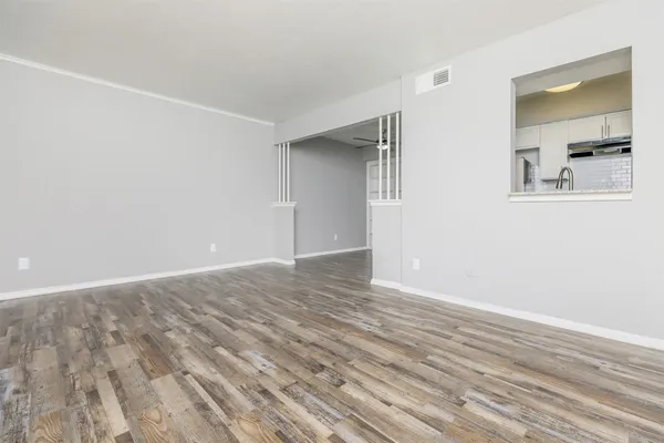 a view of a room with wooden floor and closet