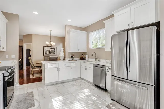 a kitchen with stainless steel appliances granite countertop a refrigerator sink and stove