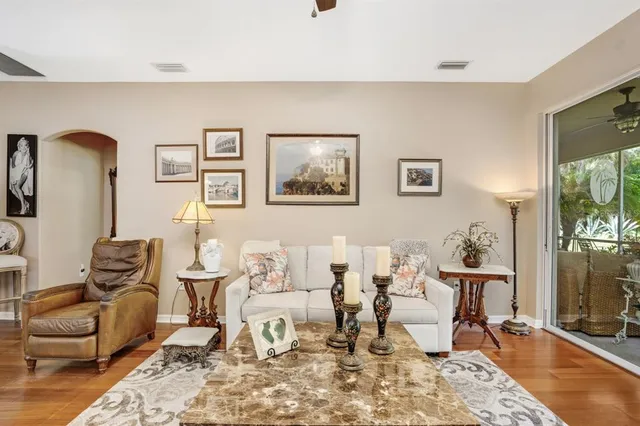 a living room with furniture and wooden floor