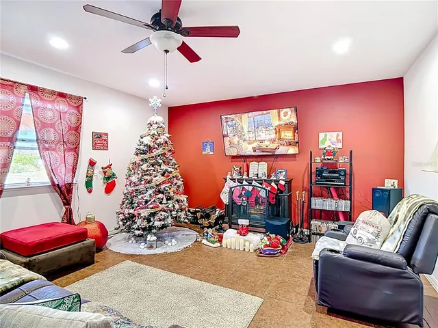 a living room with furniture and a floor to ceiling window