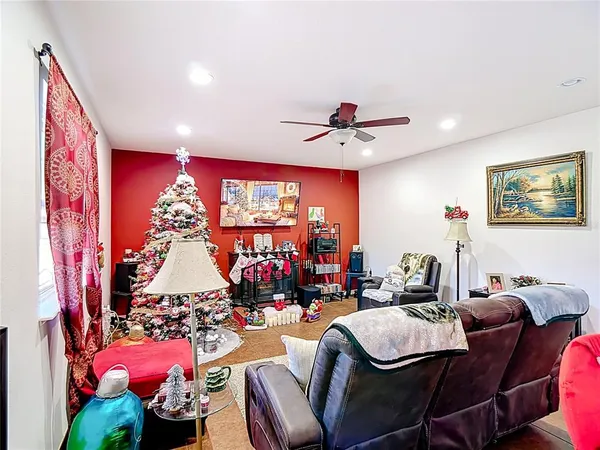 a living room with furniture flowerpot and a chandelier