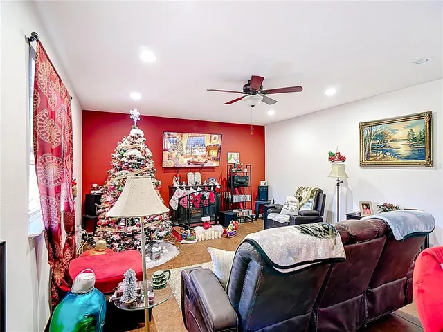a living room with furniture flowerpot and a chandelier