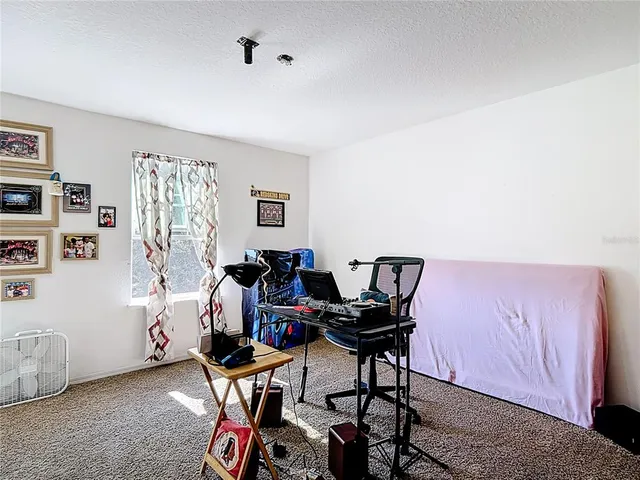 a work room with furniture and musical instruments