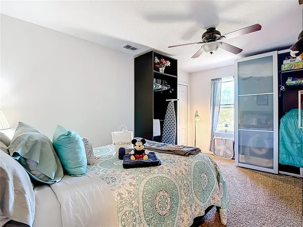 a bedroom with a bed and a chandelier